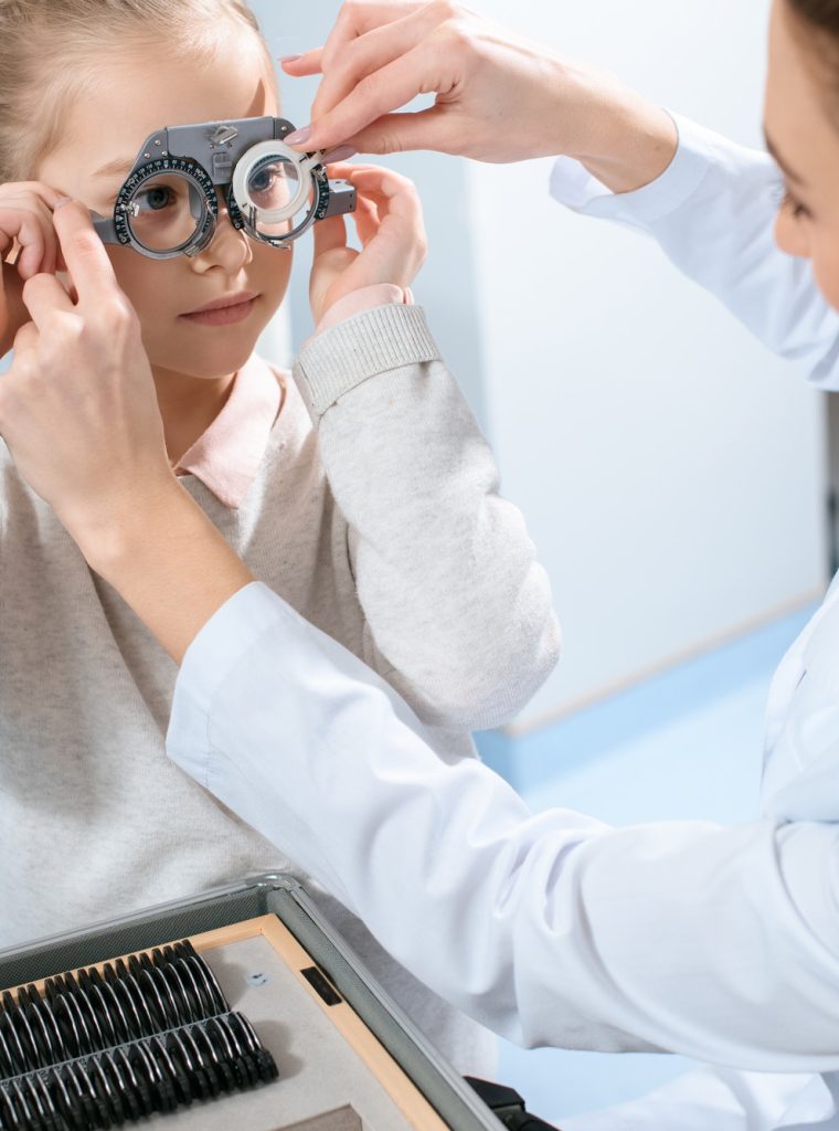female-ophthalmologist-examining-kid-eyes-with-trial-frame-and-lenses.jpg